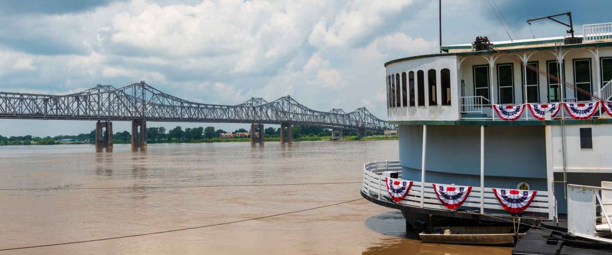 Detail of a steamer boat and the bridge over the Mississippi River near the city of Natchez, Mississippi, USA