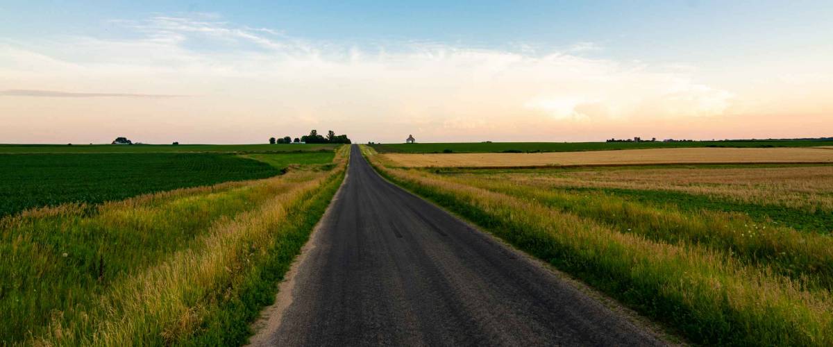 Open country road in rural Illinois as the sun sets.  LaSalle County, Illinois, USA